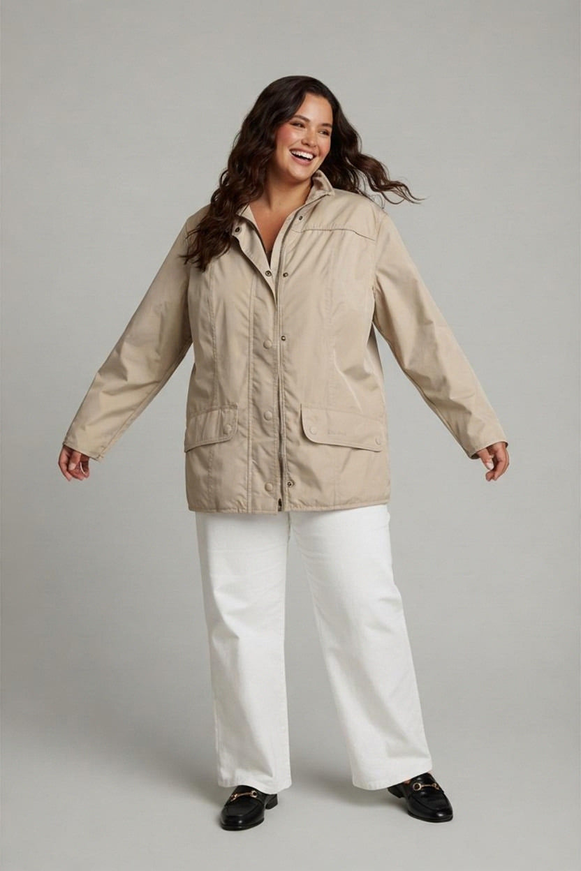 AI-generated photo of the jacket worn by a model, showing the front of the beige jacket with a zip and popper fastening, two flap pockets, and a high collar.