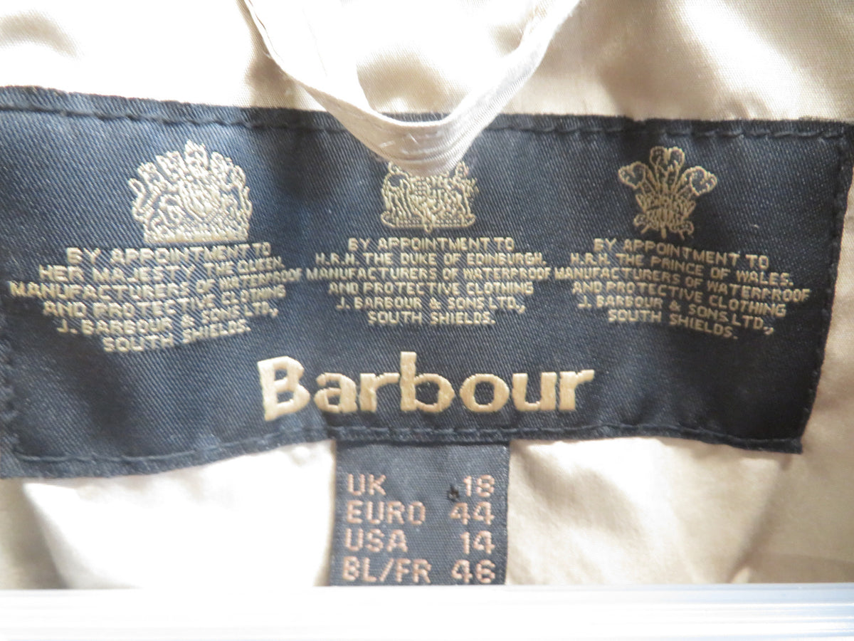 Inside neck label reading Barbour, with royal warrant text, and size markings UK 18, EURO 44, USA 14, BL/FR 46.