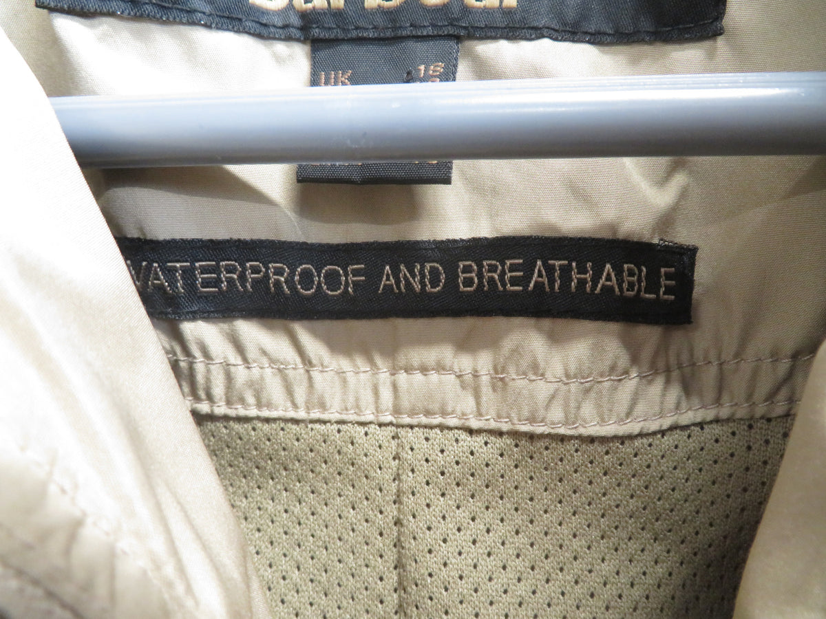 Inside neck label reading UK 18 and 'Waterproof and breathable', with a mesh lining visible at the collar.